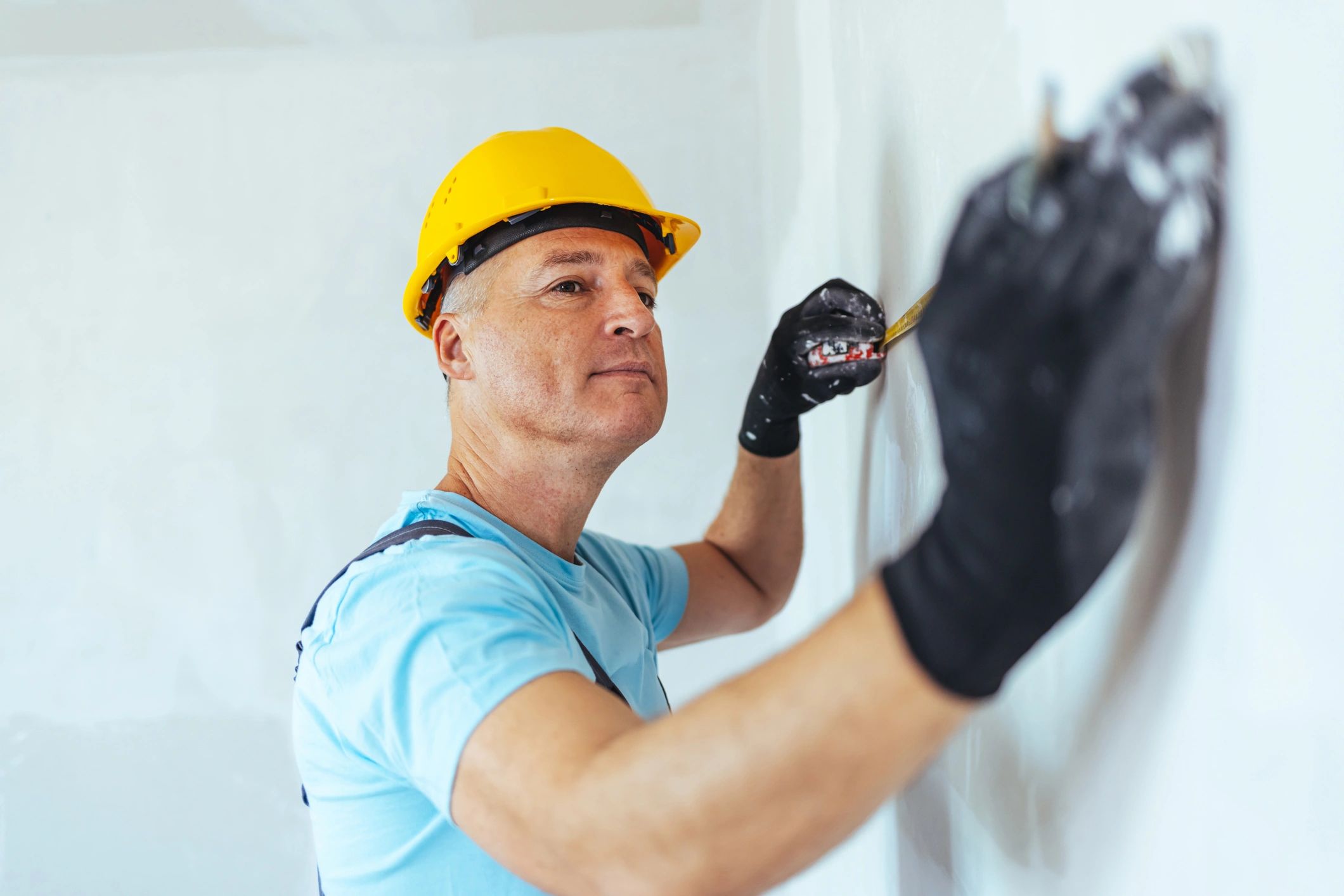 Technician measuring and marking a wall for installation