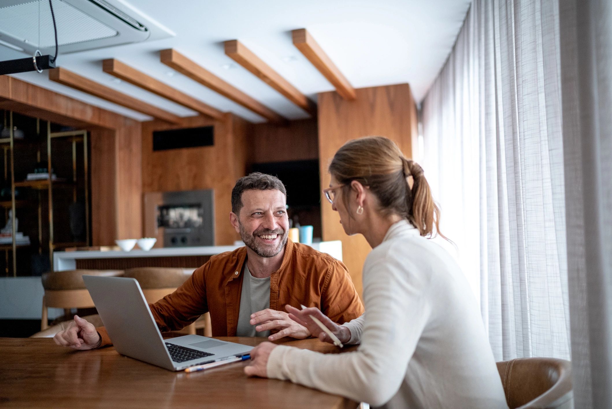 Homeowners using a laptop at home after setup assistance